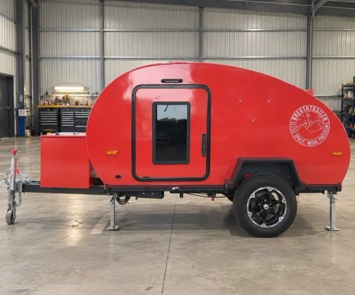 Side view of a red Plus illustrating the shared compact body; Essential equipment differs
