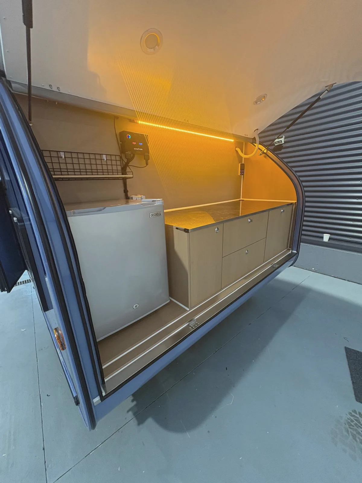 Rear kitchen with the fridge and stainless bench