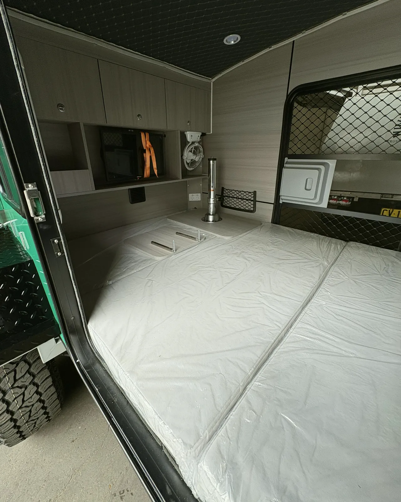 Inside the Ultra: mattress and cupboards