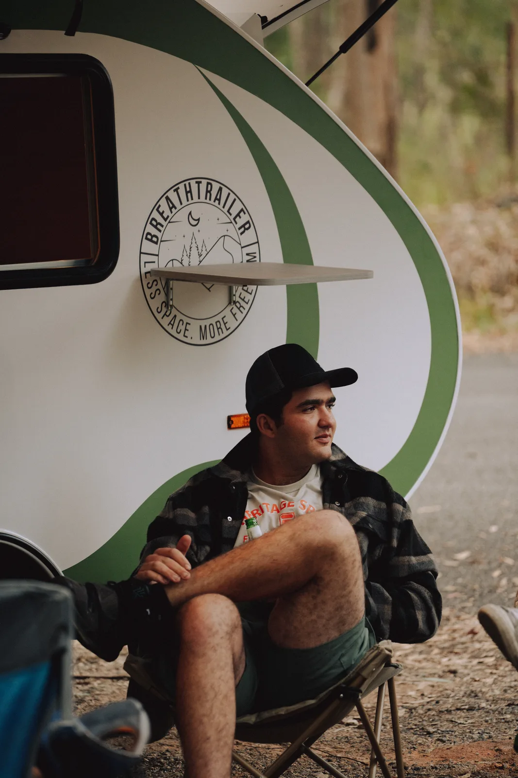 Breath Plus owner seated by the trailer logo