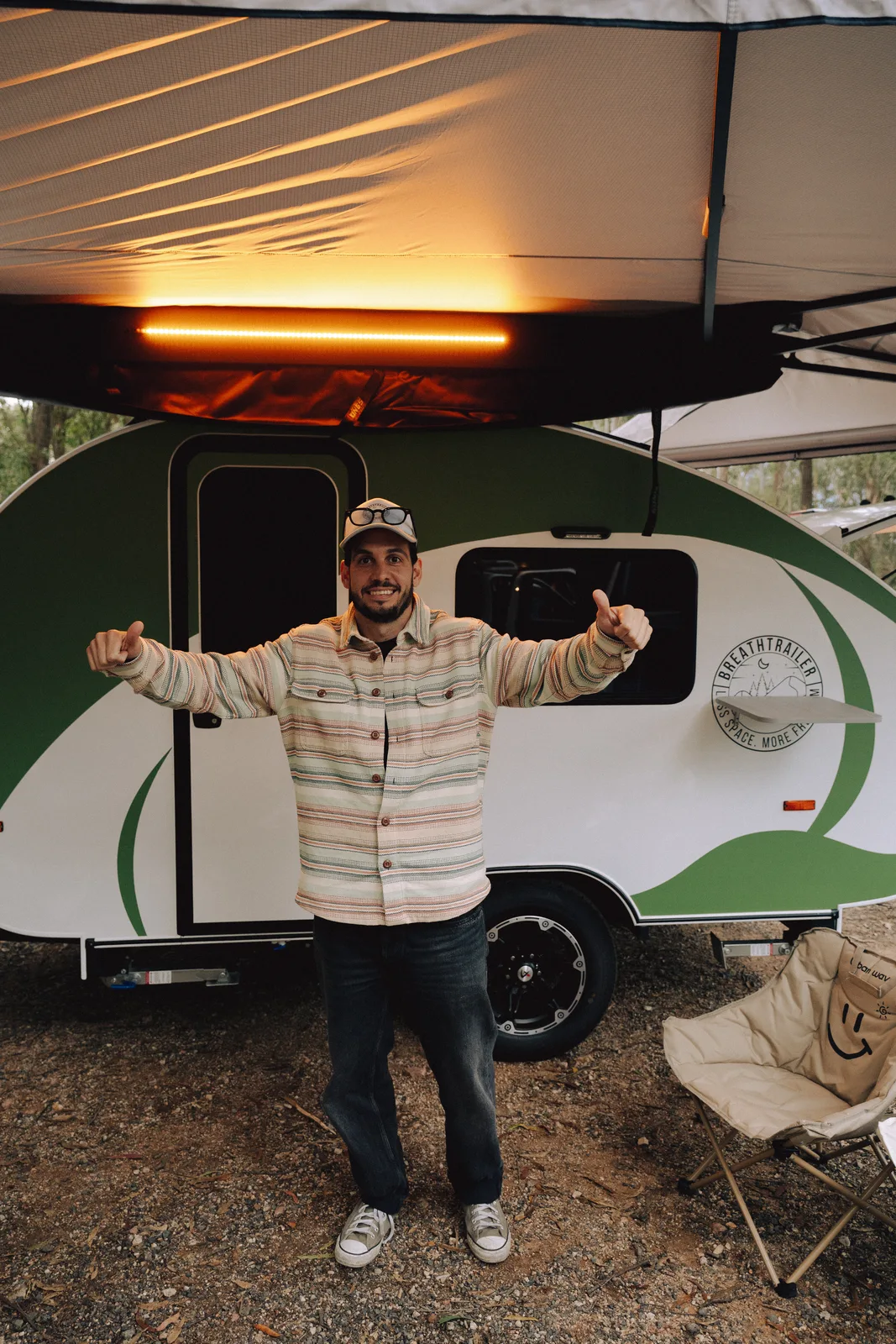 Breath Plus owner thumbs up at campsite at dusk