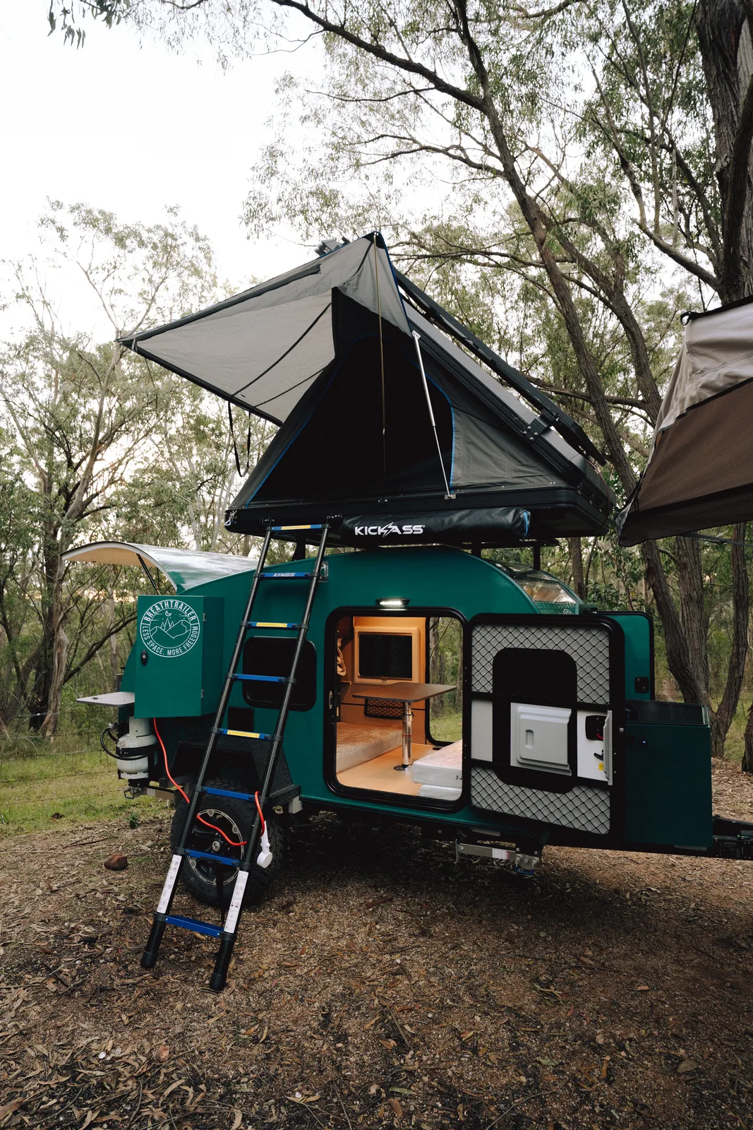 Breath Plus side view with rooftop tent extended in forest
