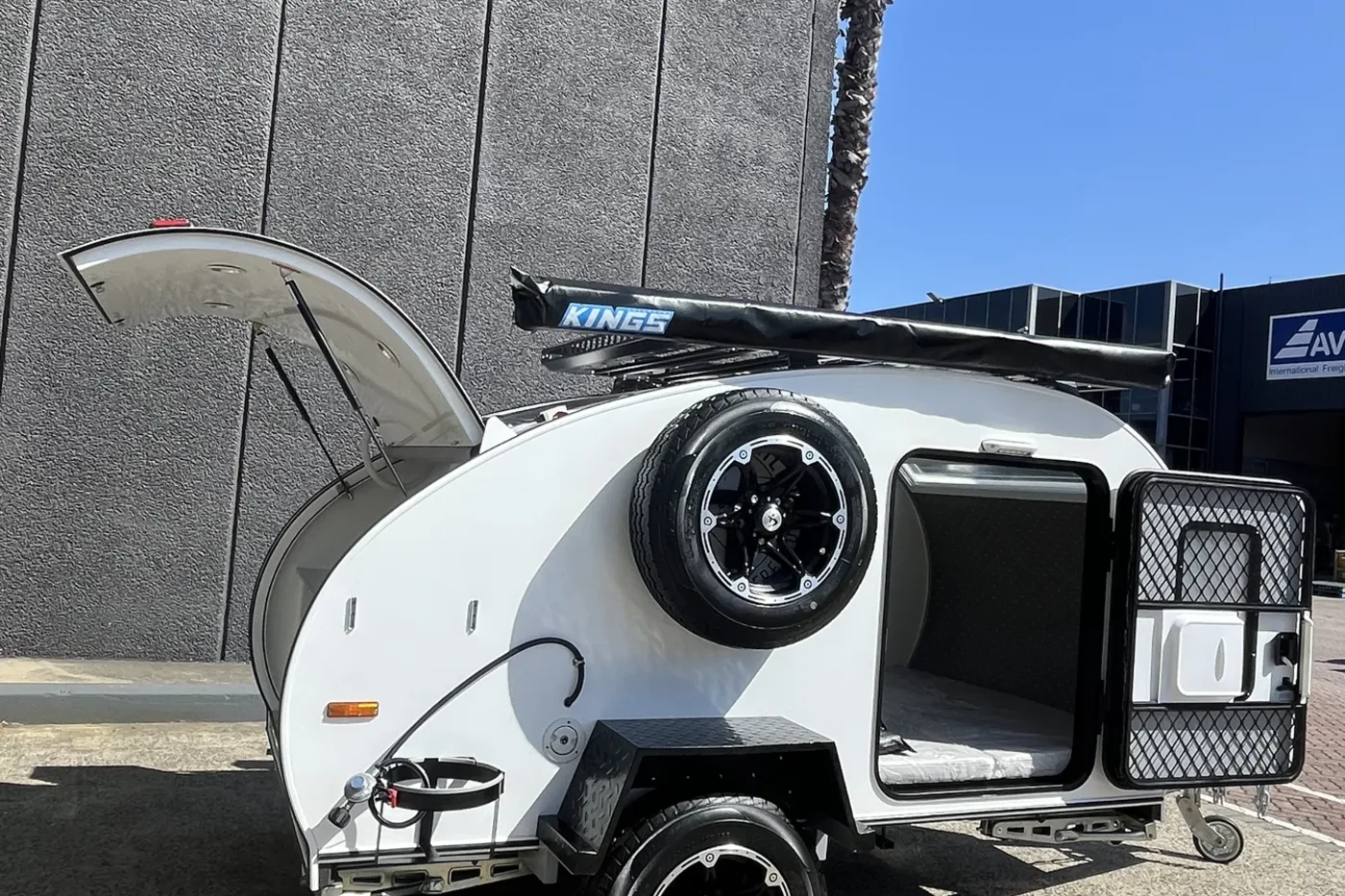 Breath Essential teardrop camper with rear kitchen hatch open