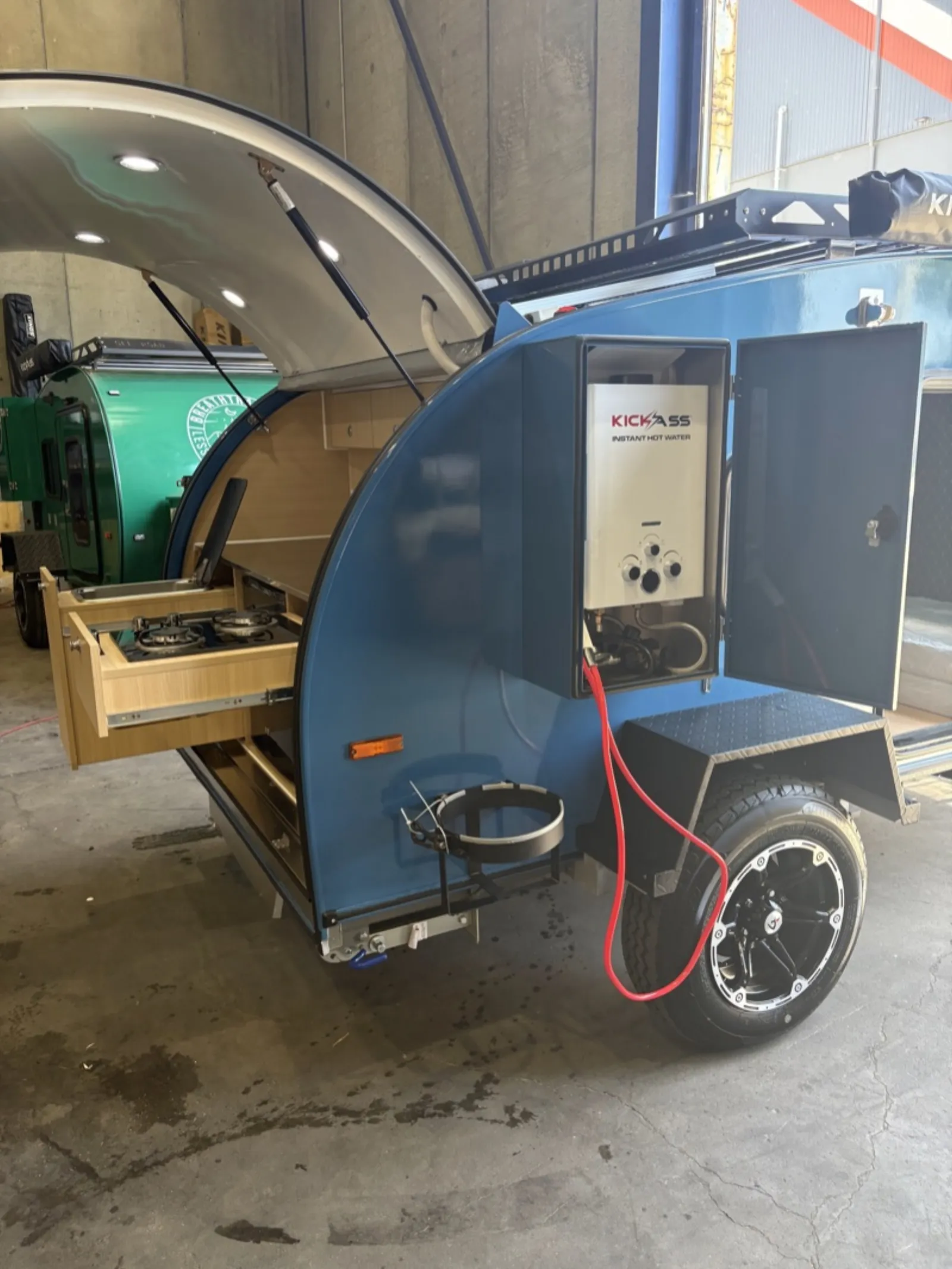 Breath Ultra in blue with slide-out two-burner stove and instant hot water unit beside the galley