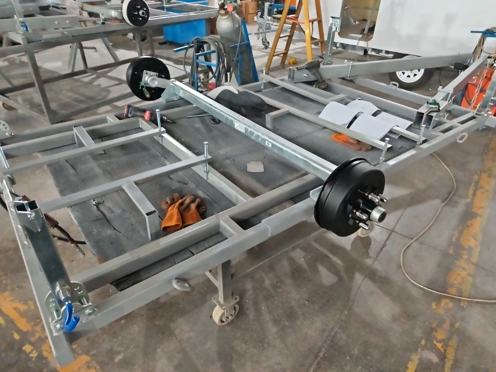 Galvanised Breath Trailer chassis with axle and brake drums fitted in the Sydney workshop, before the camper body is mounted